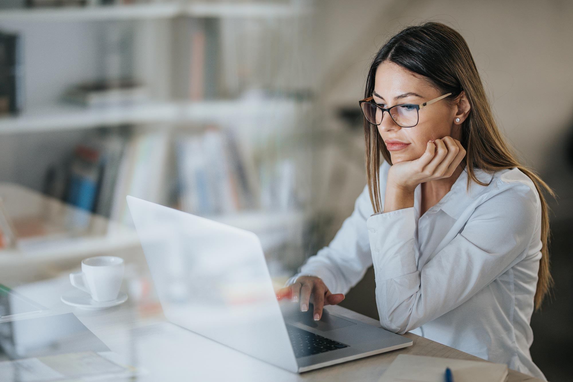 an office employee working on laptop at desk