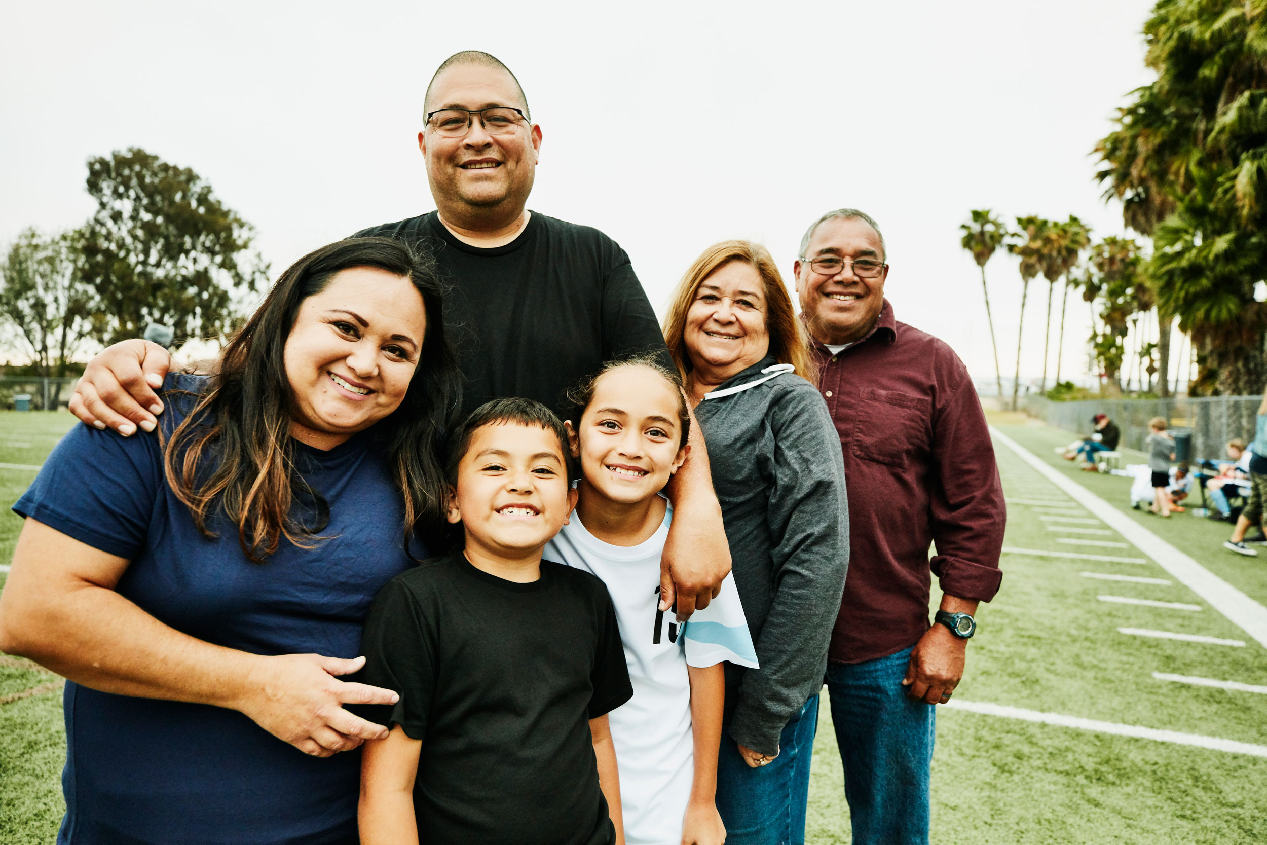 portrait image of multigenerational family on field