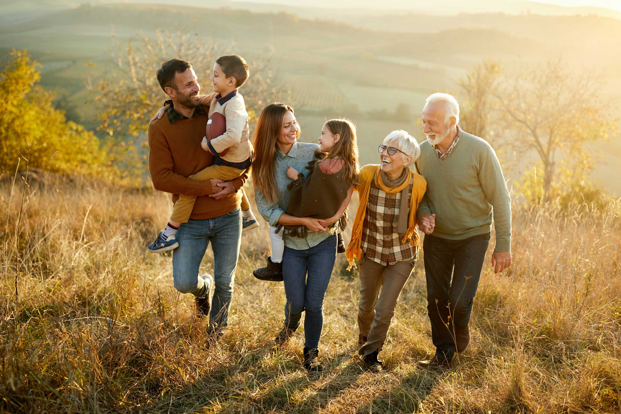 a happy multi-generational family taking a walk