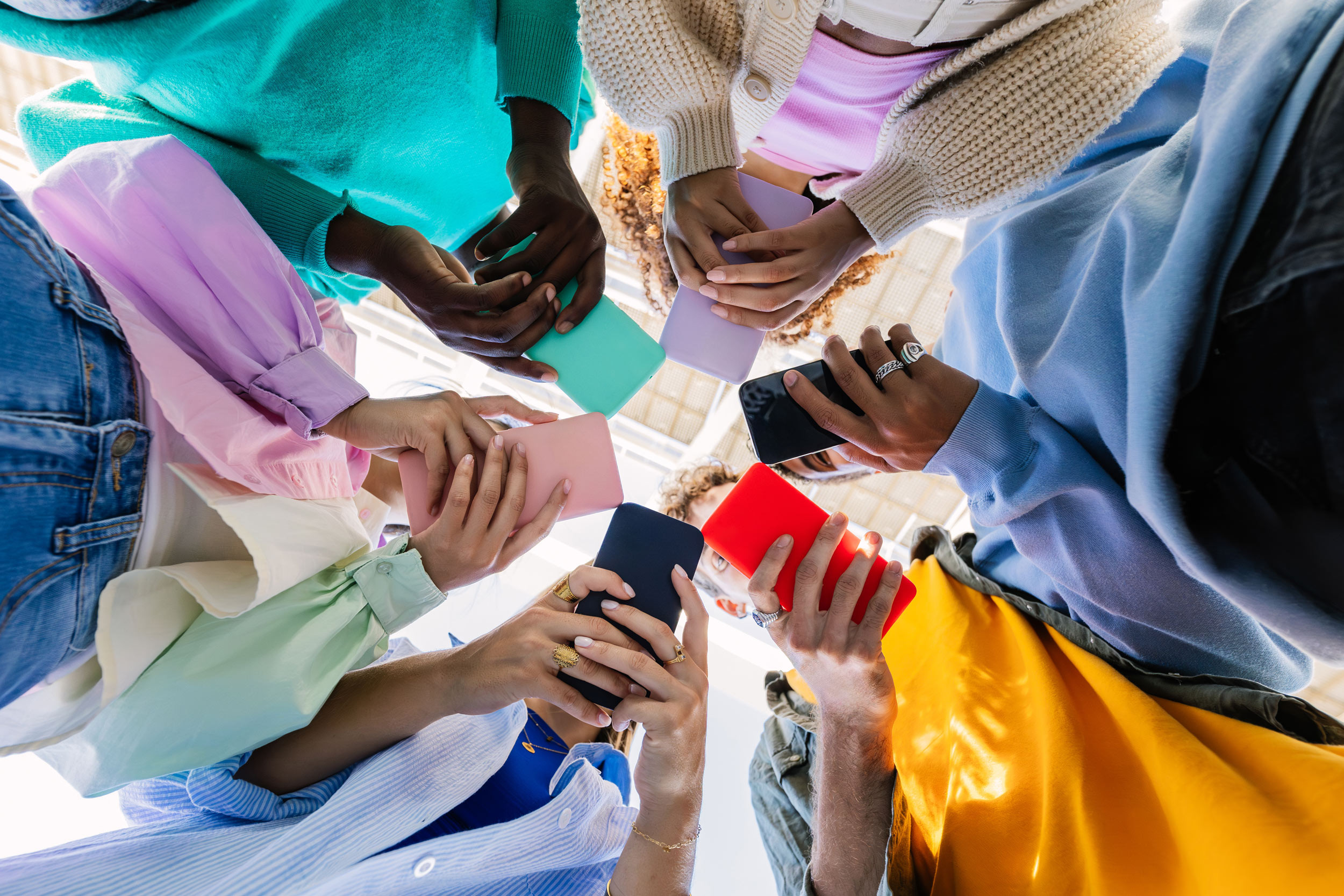 young people using colorful phones