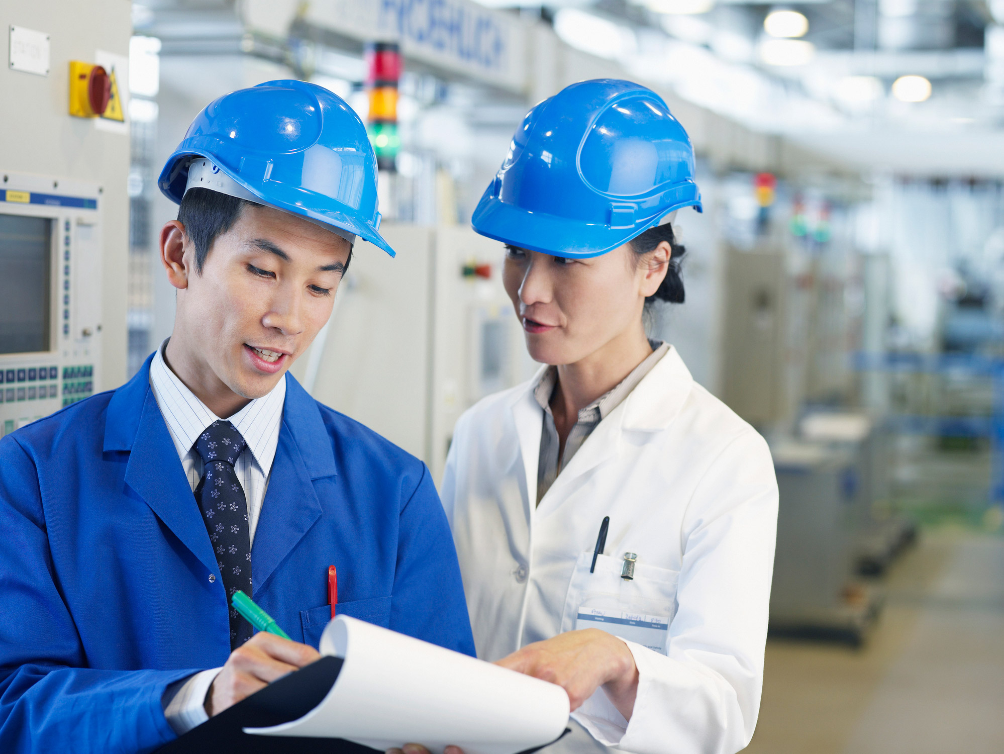 Manufacturing industry professional reviewing equipment and logistics