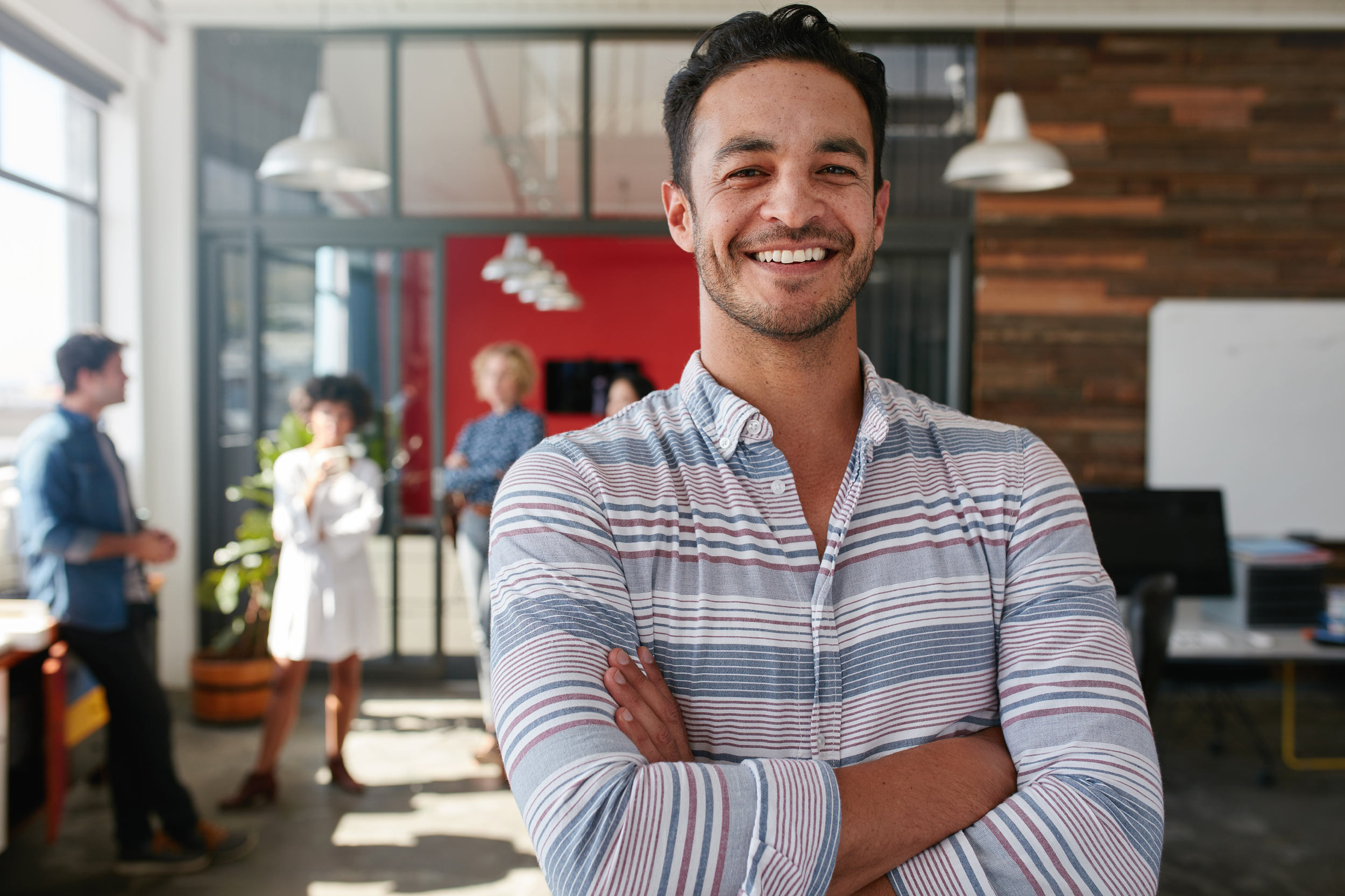 a smiling designer in the office with colleagues