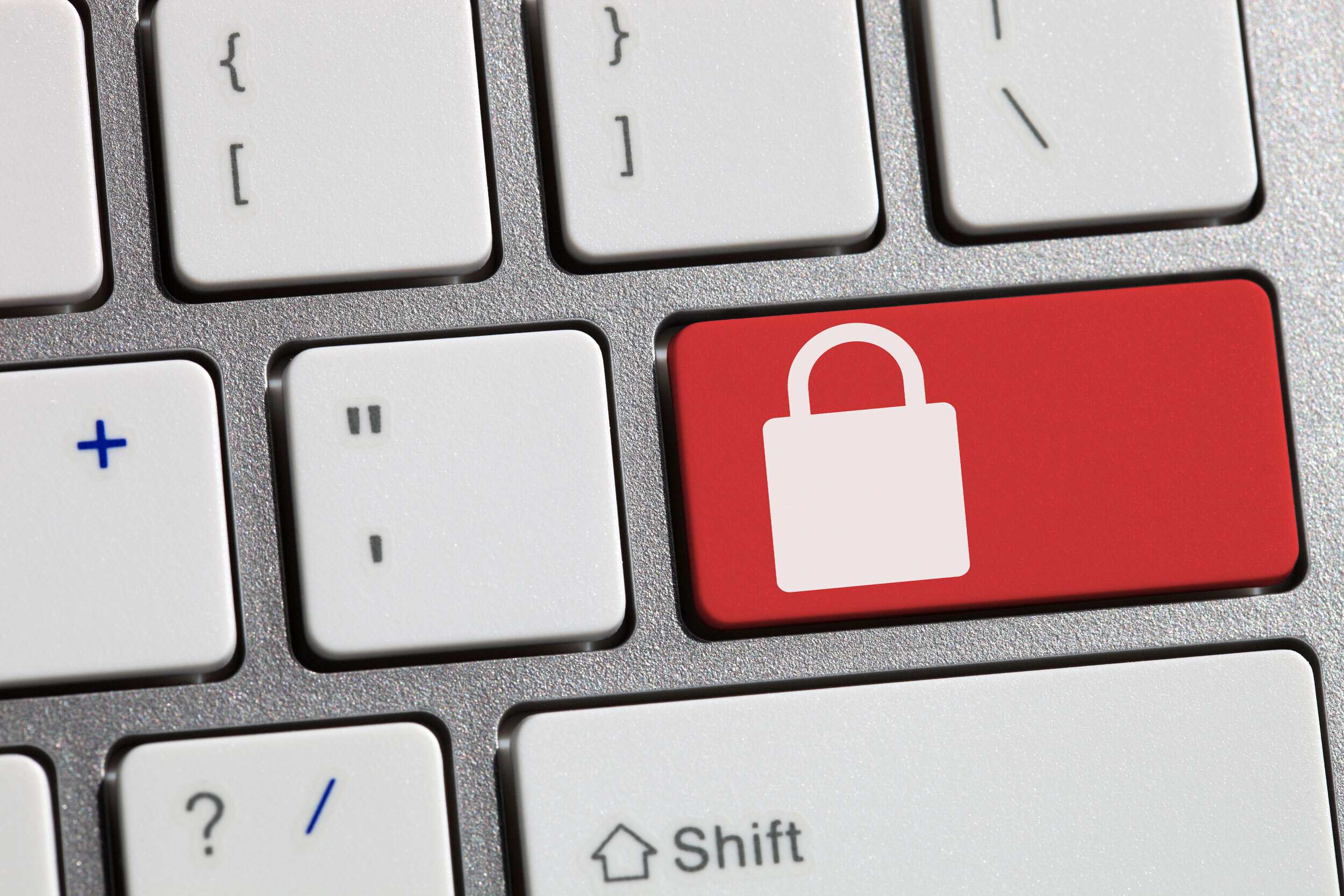 a red lock icon on a keyboard