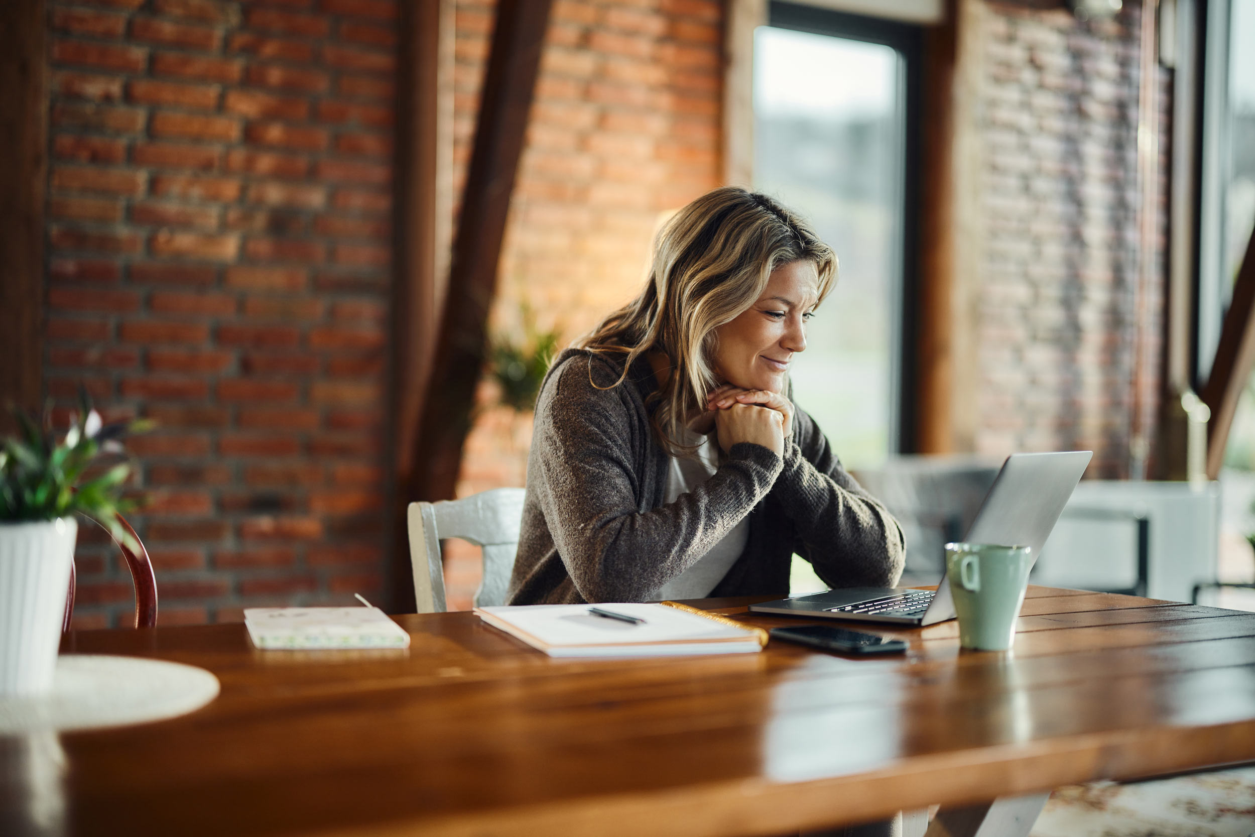 person looking at laptop in a home office