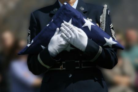 a military funeral ceremony officer holding US flag