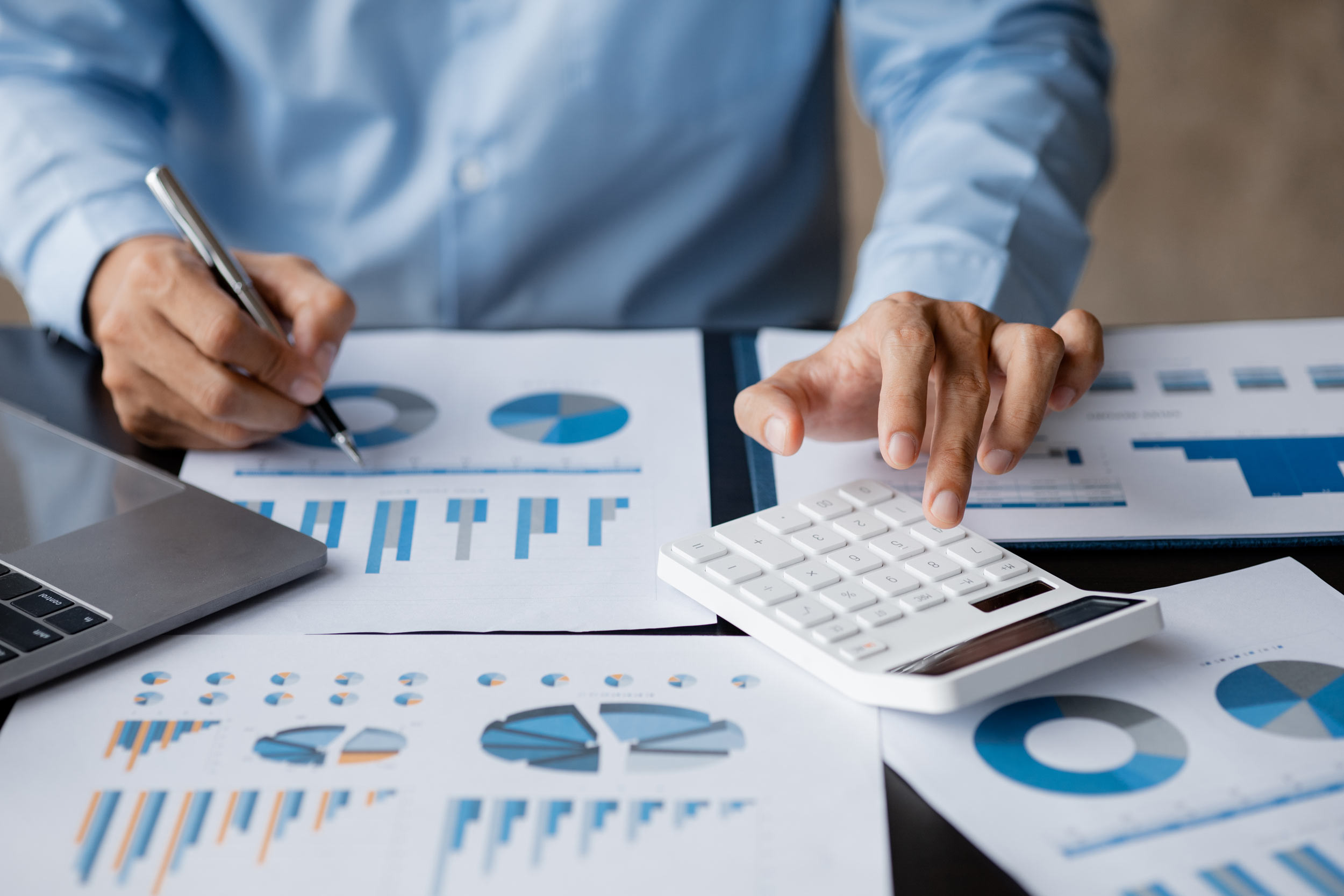an accountant working with a calculator and documents