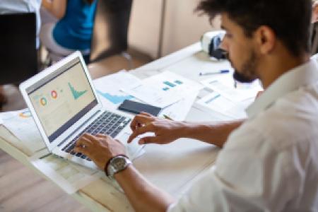 an accountant analyzing data charts on computer