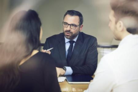 a lawyer consulting with two clients