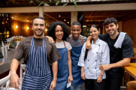 a group of smiling restaurant staff