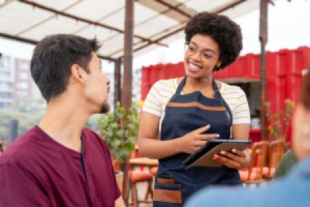 waitress taking an order in an outdoor restaurant