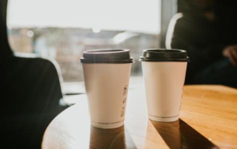 two takeaway coffee cups on a table
