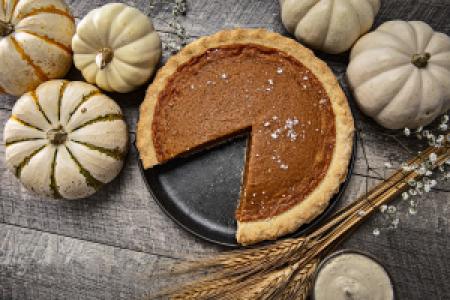 a pumpkin pie and decorative pumpkins