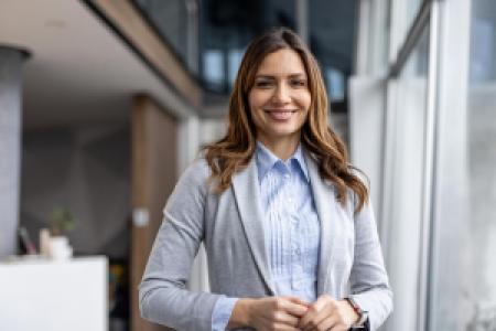 a smiling businessperson in a modern office