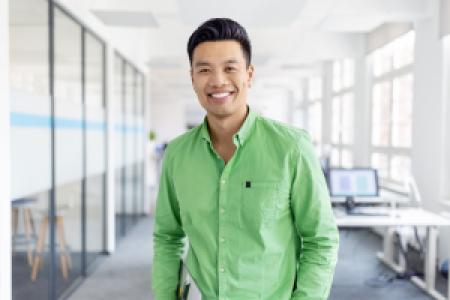 a smiling entrepreneur in an empty office