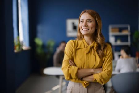 a happy CEO with crossed arms in a team meeting