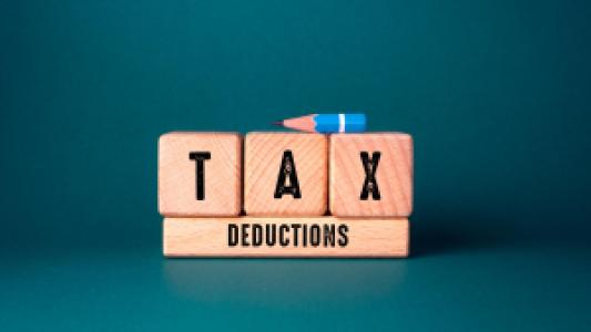 tax deductions wooden blocks and a pencil