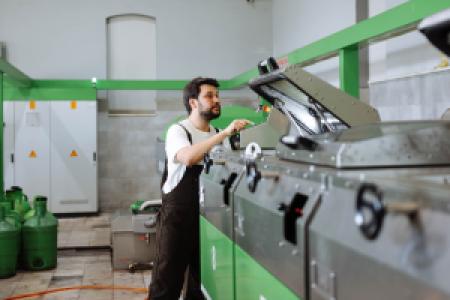 a worker in an olives factory machine