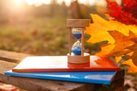 hourglass, folders on a desk in autumn