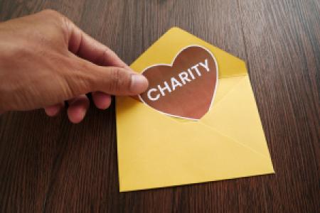 a charity letter with a cut out paper heart