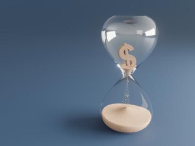 dollar sign crumbling into sand inside hourglass