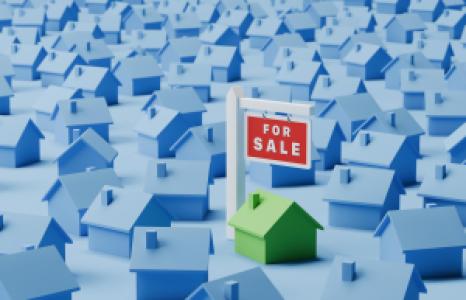 model of a house for sale among many houses