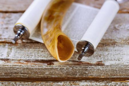 a shofar and scroll on a wooden desk