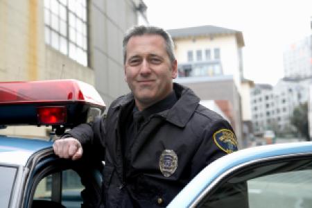 a smiling police officer