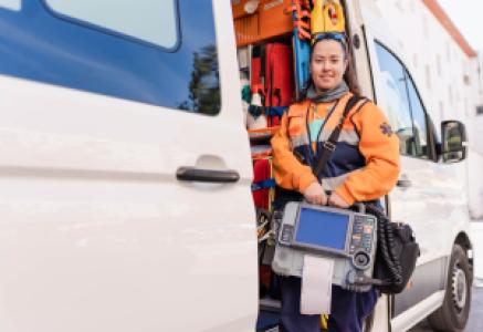 an EMT leaning on an ambulance