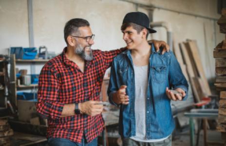 a happy father and son in the carpentry business