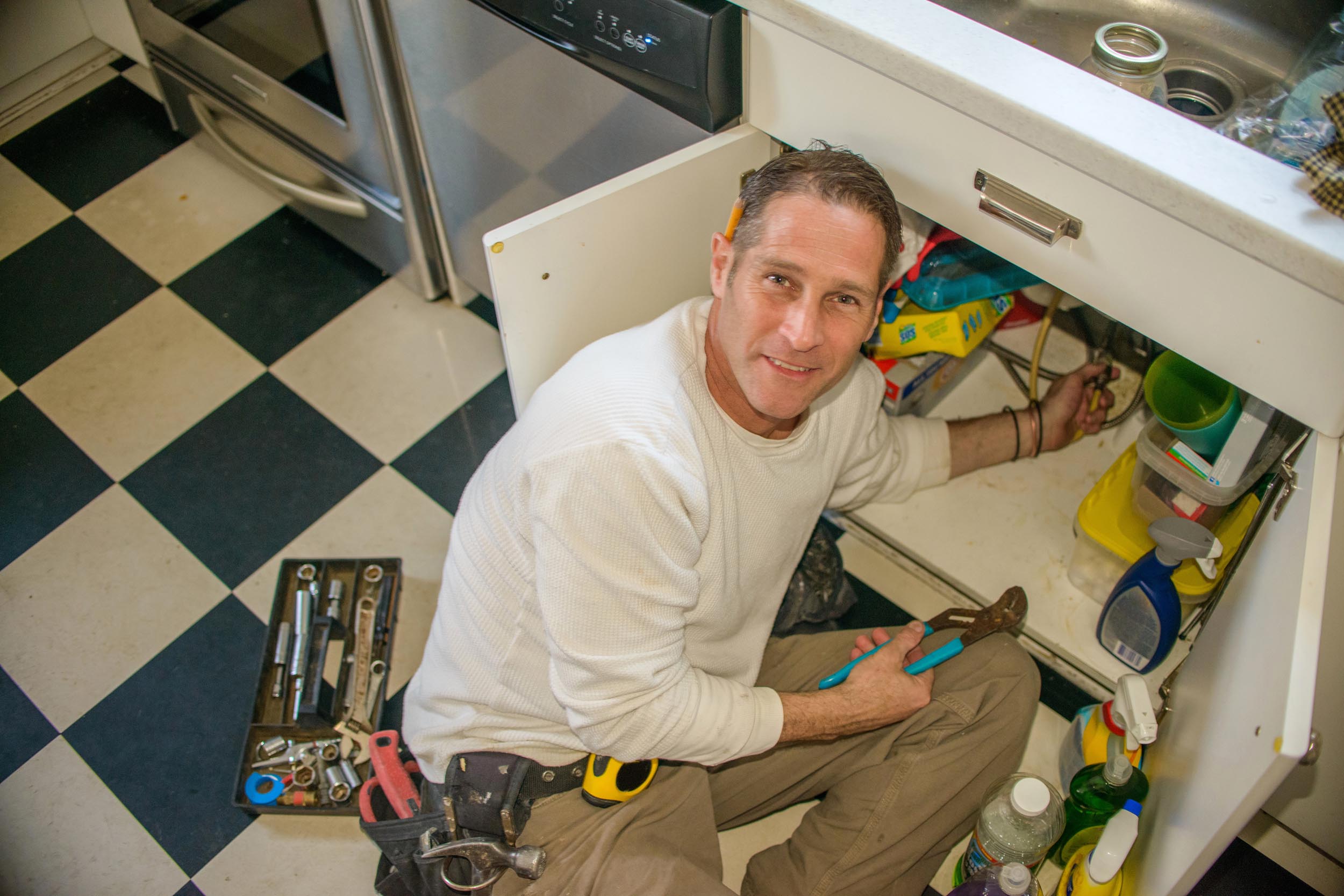 A professional fixing a leak, representing the fixing of tax leaks in a portfolio