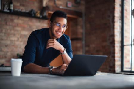 a happy entrepreneur working on laptop