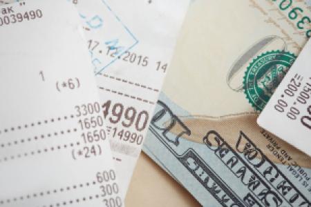 a pile of expensive receipts and bills