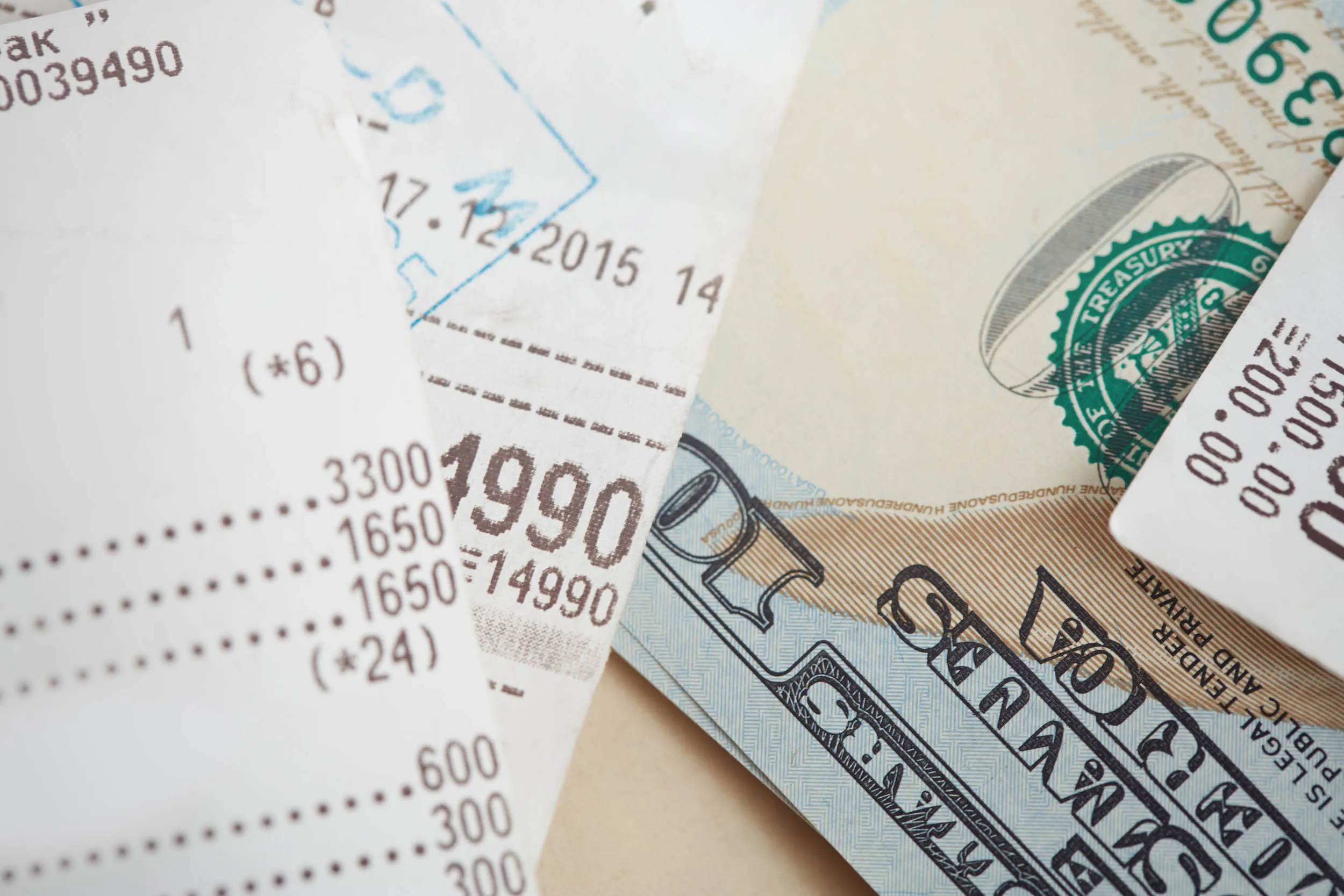 a pile of expensive receipts and bills