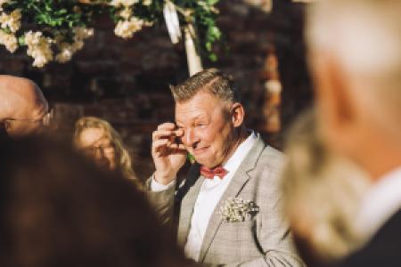 a person tearing up at a wedding ceremony
