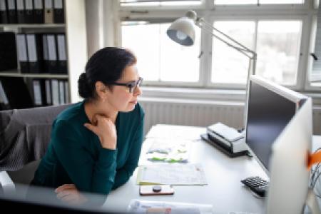 a mature person working at an office desk